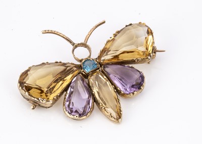 Lot 81 - An Edwardian amethyst, Citrine and aqua gem set gold butterfly brooch