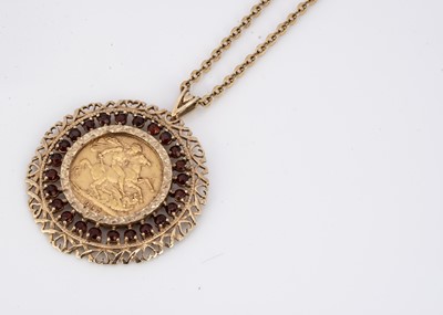 Lot 95 - A full Sovereign garnet and gold mounted pendant