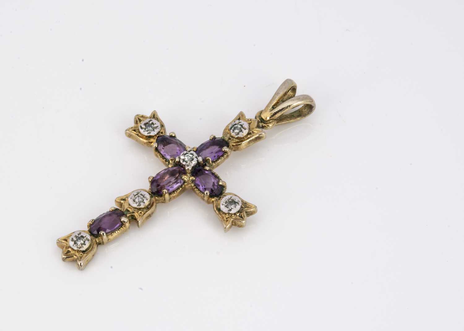 Lot 96 - A silver gilt amethyst and diamond cross pendant