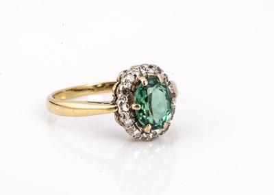 Lot 104 - A green tourmaline and diamond cluster ring