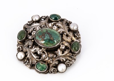 Lot 117 - A circular Arts and Crafts turquoise and mother of pearl brooch