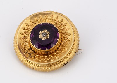 Lot 119 - A Victorian amethyst, diamond and gold roundel brooch