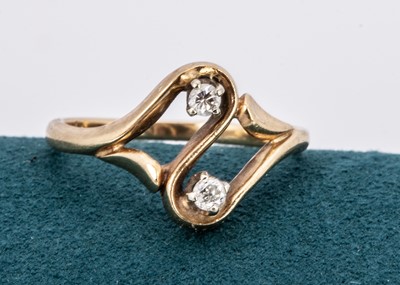 Lot 201 - A 14k marked continental diamond cross-over ring