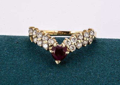 Lot 209 - A continental 750 marked ruby and gem set wishbone ring