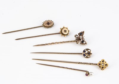 Lot 190 - A collection of six gem set and gold stick pins