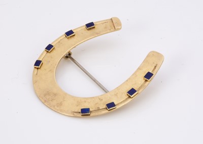 Lot 228 - A 19th century yellow metal and blue enamel horse shoe brooch