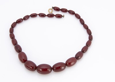 Lot 248 - A 'cherry amber' string of graduated beads