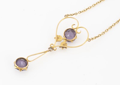 Lot 202 - An Edwardian 9ct gold amethyst and seed pearl openwork pendant and chain