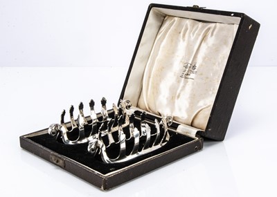 Lot 412 - A pair of nice 1970s silver toast racks by Adie Bros