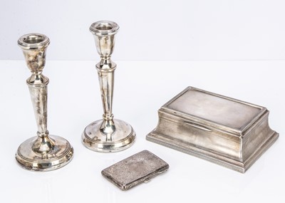 Lot 448 - A pair of 1980s silver filled candlesticks and a 1920s silver table cigarette box and a silver cigarette case