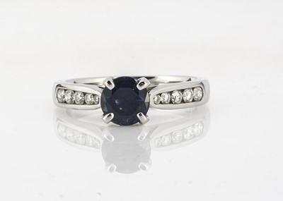 Lot 211 - A contemporary sapphire and diamond dress ring