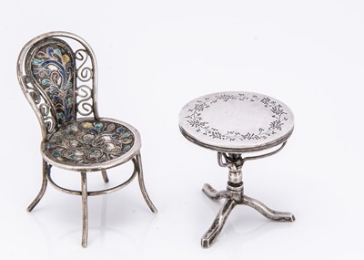 Lot 496 - A miniature table and chair