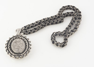 Lot 220 - A Victorian silver oval locket and circular linked chain
