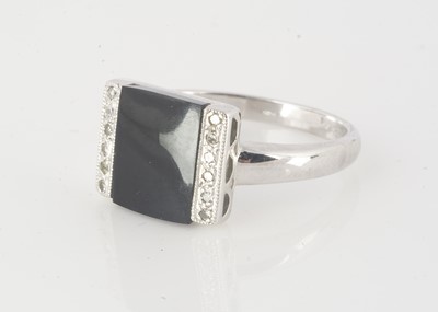 Lot 228 - A 9ct white gold onyx and diamond dress ring