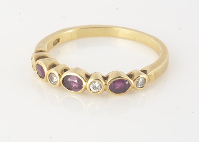 Lot 229 - A ruby and diamond seven stone half hoop dress ring