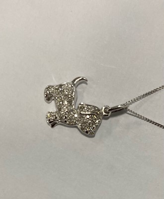 Lot 246 - A 9ct gold and diamond encrusted puppy pendant