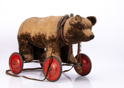 Lot 315 - A 1920s British brown mohair bear on wheels