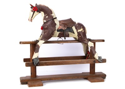 Lot 481 - An unusually small English carved and painted wooden rocking horse