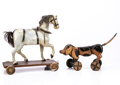 Lot 482 - A wooden horse and dachshund on wheels