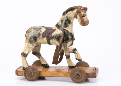 Lot 483 - A small English carved and painted wooden cart horse on wheeled platform