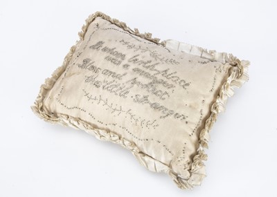 Lot 562 - An 19th century or earlier cream silk christening layette pincushion