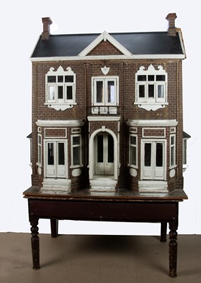 Lot 601 - A large Edwardian English wooden dolls’ house on stand