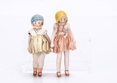 Lot 651 - Two Hertwig all-bisque dolls’ house girl dolls with moulded hats