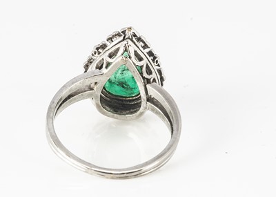 Lot 29 - A certificated emerald and diamond platinum pear shaped dress ring