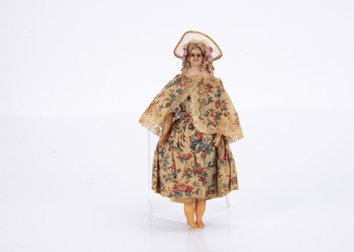 Lot 814 - A mid 19th century small or large scale dolls’ house poured wax child doll