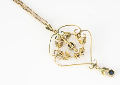 Lot 296 - A 9ct gold Edwardian sapphire and seed pearl openwork floral pendant