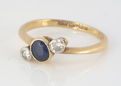 Lot 298 - An 18ct gold sapphire and diamond three stone crossover ring