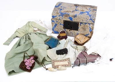 Lot 886 - A mid 19th century doll’s trunk with clothing