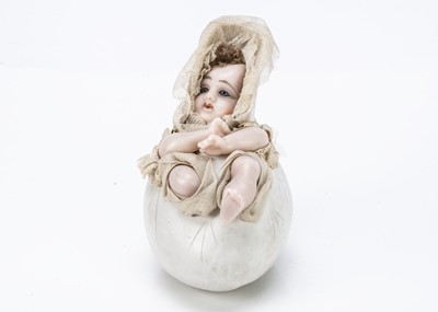 Lot 921 - A German wax baby in egg candy containers circa 1910