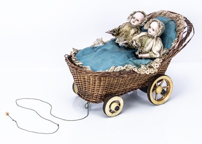 Lot 923 - A rare 19th century musical pull-along toy of twin babies in a cradle