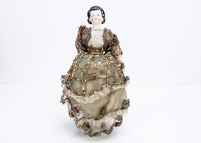 Lot 989 - An unusual 19th century china shoulder-head doll in elaborate theatrical costume