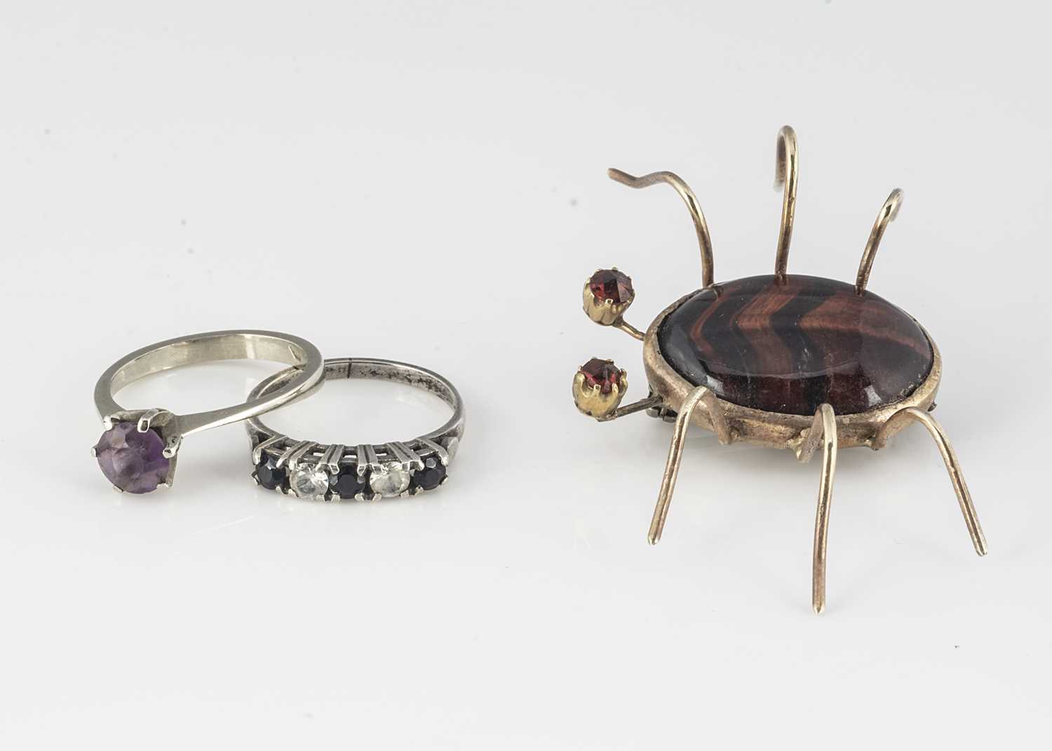 Lot 361 - A red tigers eye and garnet silver mounted bug brooch