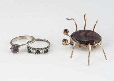 Lot 361 - A red tigers eye and garnet silver mounted bug brooch
