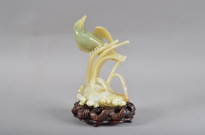 Lot 114 - A 20th century Chinese carved hardstone bird on a branch