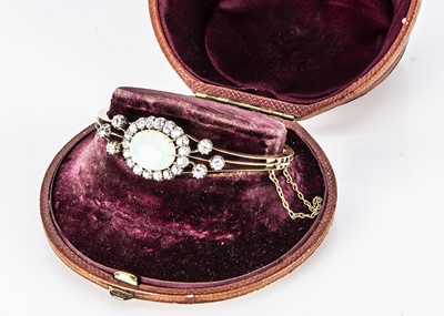 Lot 39 - An Edwardian precious opal and diamond bangle