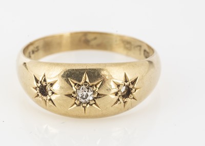 Lot 40 - An 18ct gold three stone gypsy set diamond dress ring