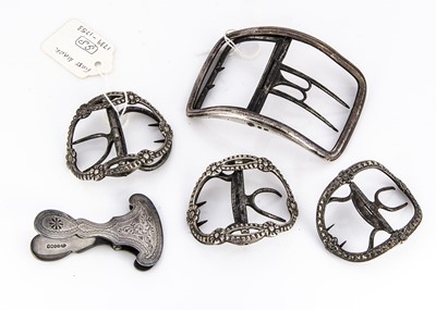 Lot 458 - Four Georgian silver and later buckles and a silver plated skirt clip