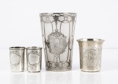 Lot 507 - An early 20th century Russian opaque and silver mounted glass beaker and three silver other beakers