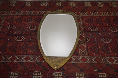 Lot 15 - An Art Nouveau shield shape brass wall mirror