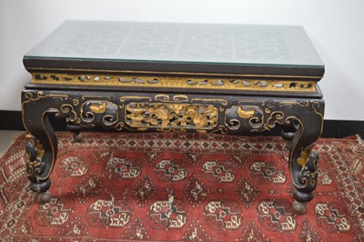 Lot 23 - A Chinese style black lacquer and gilt wood coffee table 