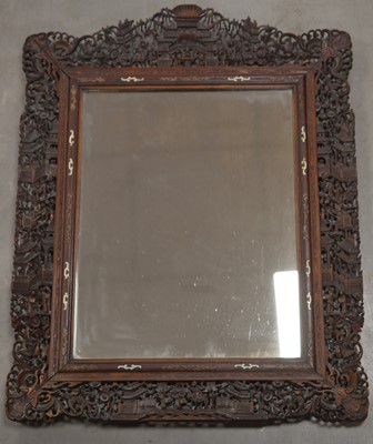 Lot 41 - A late 19th-Early 20th century ornately carved Chinese mirror