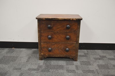 Lot 63 - A miniature patinated pine folk-art chest of drawers