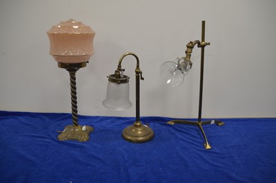 Lot 77 - An Edwardian brass table lamp and two others