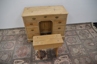 Lot 105 - An early 20th Century pine kneehole desk and associated stool