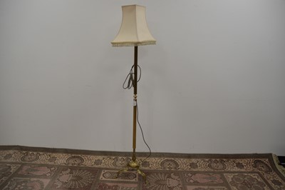 Lot 125 - A brass standard lamp with a tripod base