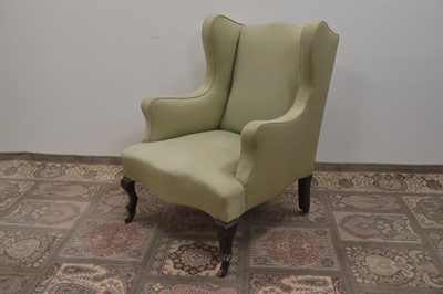 Lot 127 - A 19th Century wingback armchair